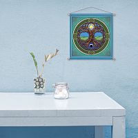 Minimalist scene evoking tranquility, with an almost bare tabletop, and the Tree of Life banner hanging on a pale blue wall.