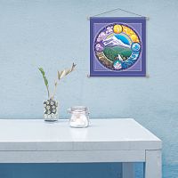 Minimalist scene evoking tranquility, an almost bare tabletop, and the Rainbow Mountain banner hanging on a pale blue wall.