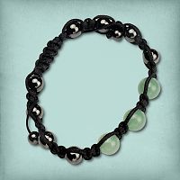 Green Aventurine Shamballa Bracelet showing metallic grey hematite beads and soft green aventurine beads on a black cord.