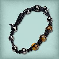 Tiger Eye Shamballa Bracelet showing metallic grey hematite beads and golden brown tiger eye beads on a black cord.