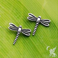 Closeup of sterling silver dragonfly post earrings in a model's ear, highlighting the subtle texturing on the dragonfly wings.