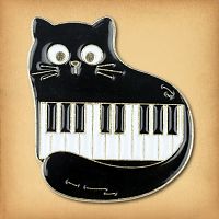 The Piano Cat Enamel Pin features a cartoon-style plump black cat curled around a short piece of a piano keyboard.