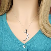 Eye-catching Sterling Silver Lunar Magic Pendant on a delicate chain, showcased on a woman's neckline.