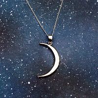 Sterling Silver Lunar Magic Pendant against a field of stars, highlighting its celestial nature and graceful shape.
