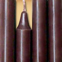 Closeup of a quartet of brown chime candles arranged side-by-side so they form an almost solid block of color.