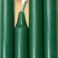 Closeup of a quartet of forest green chime candles arranged side-by-side so they form an almost solid block of color.