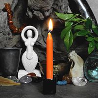 Orange candle on altar