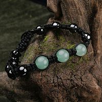 Green Aventurine Shamballa Bracelet displayed on moss-covered wood, highlighting its natural gemstone beads and macrame knots