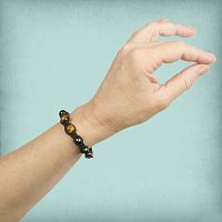 Tiger Eye Shamballa Bracelet being worn on a female wrist, showing the three larger golden brown accent beads.