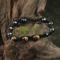 Tiger Eye Shamballa Bracelet displayed on moss-covered wood, highlighting its natural gemstone beads and macrame knots.
