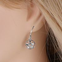Silver Domed Pentacle Earring worn by a model, highlighting the simple elegance of the dangling pentacle charm.