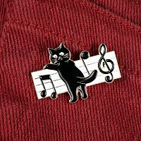The Music Cat Enamel Pin worn on brick-red denim jeans, showcasing its casual charm. Perfect for music- and cat-lovers.