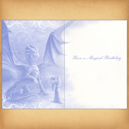 The inside of the card displays a monochromatic blue illustration of a dragon and enchantress, and "Have a Magical Birthday".