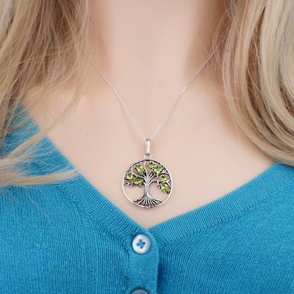 Sterling Silver Peridot Tree Pendant worn by a model, showcasing its stunning tree design and genuine peridot gemstones.