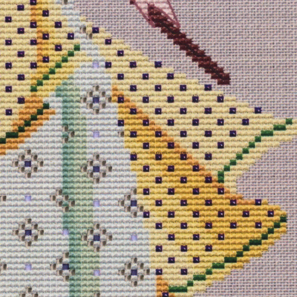 Close-up of the Dance of the Vernal Equinox cross stitch design, featuring the patterned beadwork on the golden overskirt.